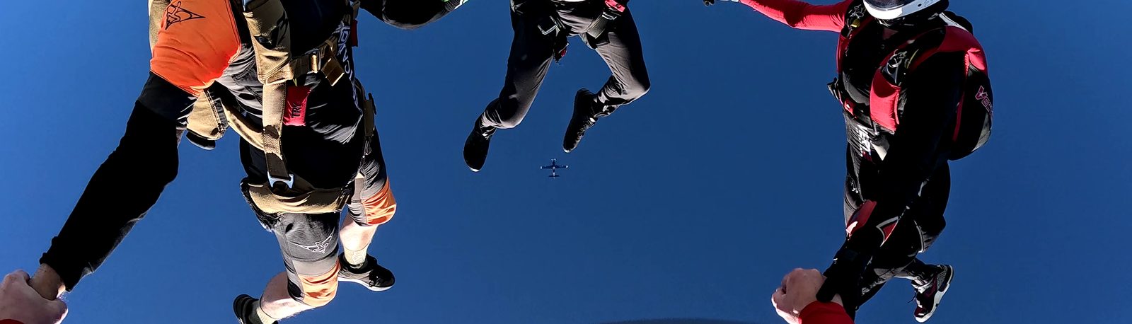 Outside Centre's point of view on a head-down base just after it stops rotating, with the aircraft framed between Inside Centre's legs — the sight picture Outside Centre steers to.